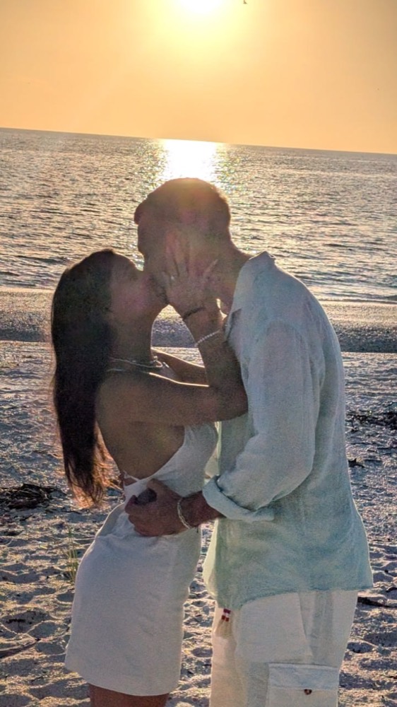 A couple embracing at sunset on a romantic cruise near Naples, Florida