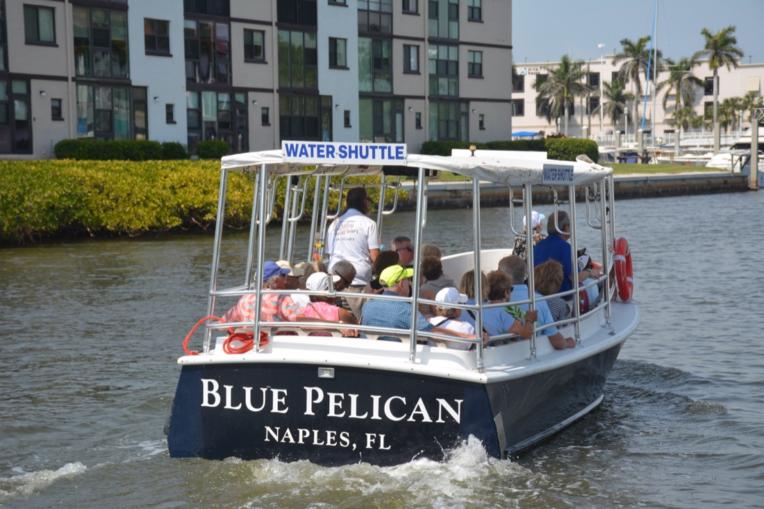 The Blue Pelican Naples Water Shuttle full of guests on Naples Bay
