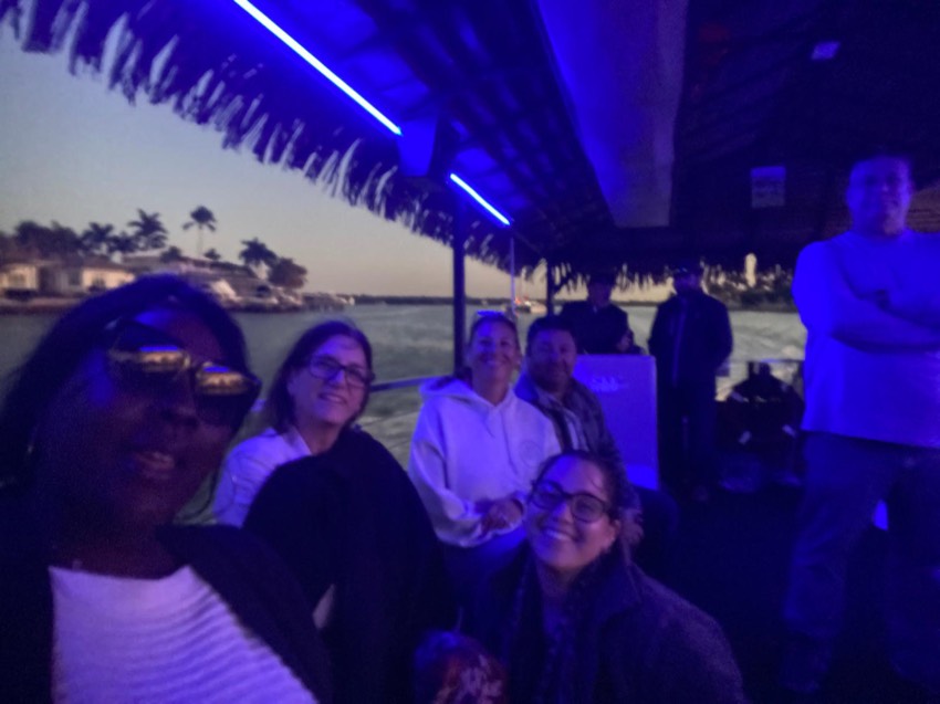 The tiki boat glowing with color-changing LED lights at night near Marco Island