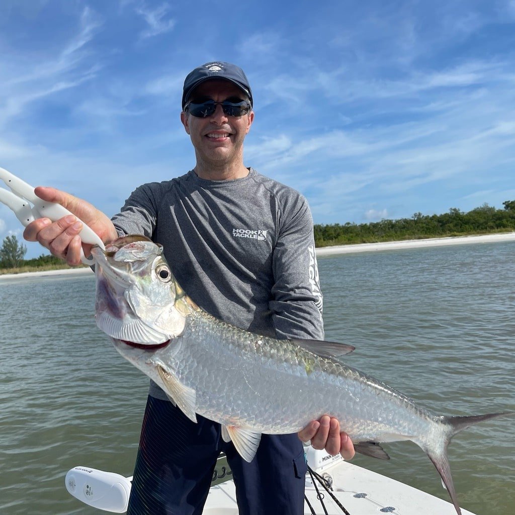 A guest fighting a tarpon on a Sand Dollar fishing charter near Naples and Marco Island