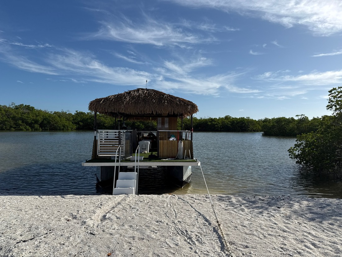 The Sand Dollar tiki boat beached on a Ten Thousand Islands sandbar